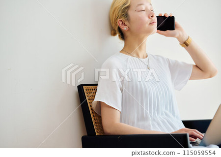 A woman operating a smartphone at home A woman operating a smartphone at home 115059554