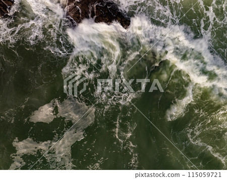 Aerial view of Waves crashing on seashore,Sea surface ocean waves background Aerial view of Waves crashing on seashore,Sea surface ocean waves background 115059721