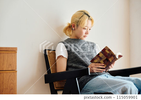 A woman reading a book 115059901
