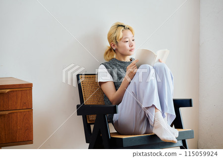 A woman reading a book A woman reading a book 115059924