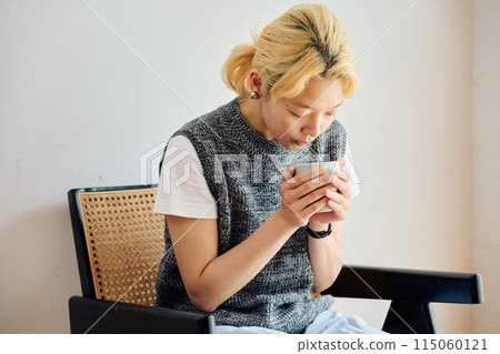 A woman relaxing in the room A woman relaxing in the room 115060121