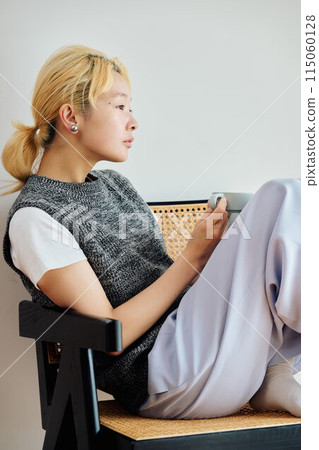 A woman relaxing in the room 115060128