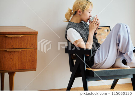 A woman relaxing in the room A woman relaxing in the room 115060130