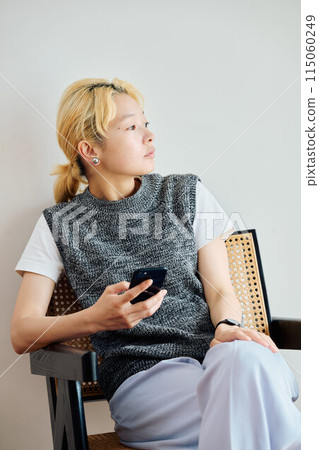 A woman who operates a smartphone in the room A woman who operates a smartphone in the room 115060249