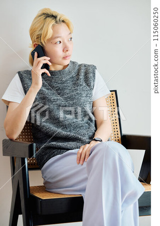 A woman who operates a smartphone in the room A woman who operates a smartphone in the room 115060250