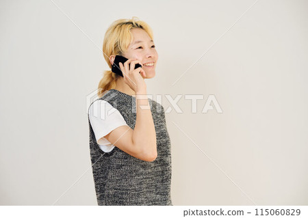 Portrait of a blonde woman making a phone call 115060829