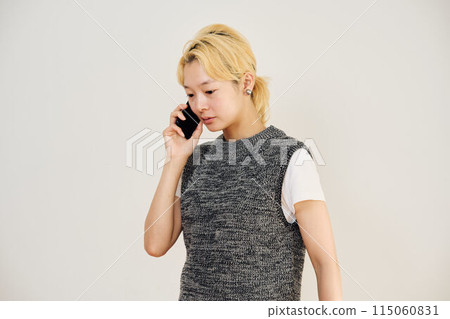 Portrait of a blonde woman making a phone call 115060831
