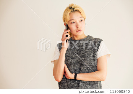 Portrait of a blonde woman making a phone call 115060840