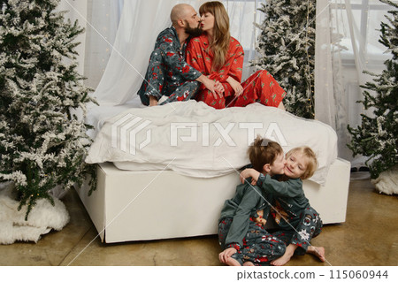 A large family with children posing in pajamas in New Year's locations. A large family with children posing in pajamas in New Year's locations. 115060944