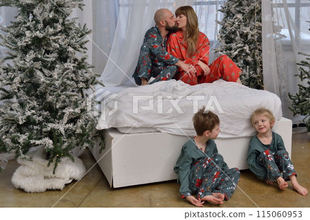 A large family with children posing in pajamas in New Year's locations. 115060953