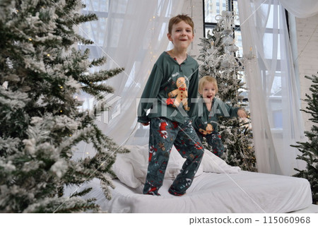 A large family with children posing in pajamas in New Year's locations. A large family with children posing in pajamas in New Year's locations. 115060968