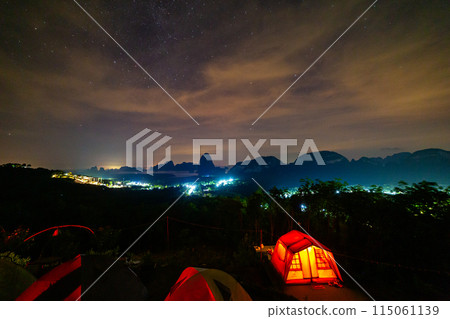 Orange sleeping tent on the top of the mountain to admire the scenery. 115061139