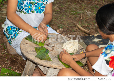 Mayan women preparing tamal dough for the Hanal Pixan, day of the dead, Yucatan, Mexico 115063299