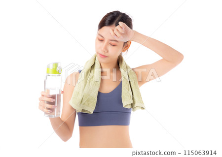 Fit young asian woman taking a break from workout holding a clear water bottle. 115063914