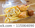 Potatoes and fried chicken from a food truck 115064090