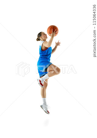 Side view portrait of professional female basketball player jumping with ball ready to score goal against white studio background. 115064336