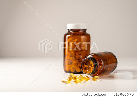 Brown glass bottle with vitamins food supplement, health and wellness Brown glass bottle with vitamins food supplement, health and wellness 115065579