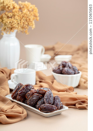 Dates in white dish on a beige background. 115065663