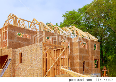 Unfinished interior of newly built house with wooden stud timber framing 115065702