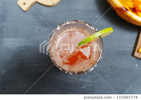 Mexican cocktail, michelada, made with beer and tomato juice. Selective focus Mexican cocktail, michelada, made with beer and tomato juice. Selective focus 115065774