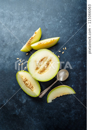 Cantaloupe, melon fruit slice over dark background. Top view Cantaloupe, melon fruit slice over dark background. Top view 115066063