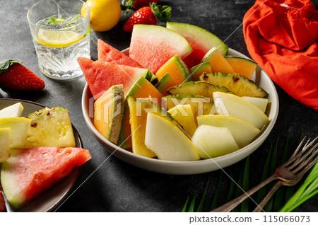 Fruits assortment platter antipasti, watermelon, pineapple, melon and strawberries. Dark background Fruits assortment platter antipasti, watermelon, pineapple, melon and strawberries. Dark background 115066073