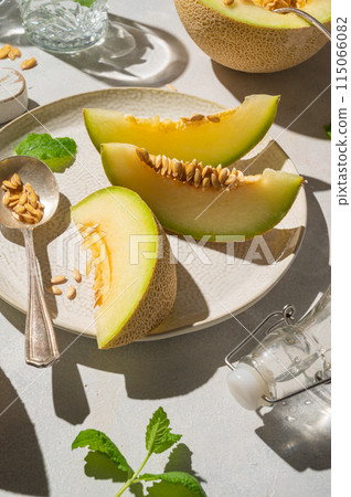 Cantaloupe, melon fruit slice over bright background.  115066082