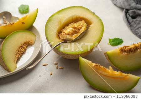 Cantaloupe, melon fruit slice over bright background. Cantaloupe, melon fruit slice over bright background. 115066083