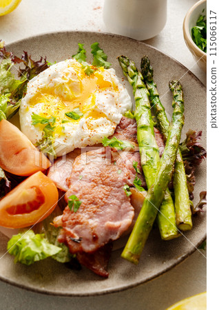 Healthy breakfast - asparagus wrapped with bacon, benedict poached egg and salad. Healthy breakfast - asparagus wrapped with bacon, benedict poached egg and salad. 115066117