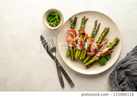Wrapped asparagus with bacon in a plate. Top view Wrapped asparagus with bacon in a plate. Top view 115066118