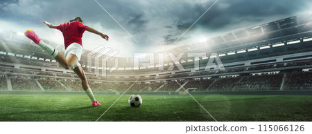 Focused and concentrated female soccer player in motion hitting ball in outdoor football arena. 3D stadium. Banner. Focused and concentrated female soccer player in motion hitting ball in outdoor football arena. 3D stadium. Banner. 115066126