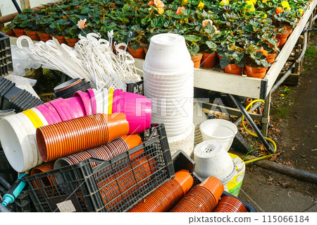 Plastic flower pots pile of different sizes and colors in the greenhouse, flower nursery farm inside Plastic flower pots pile of different sizes and colors in the greenhouse, flower nursery farm inside 115066184