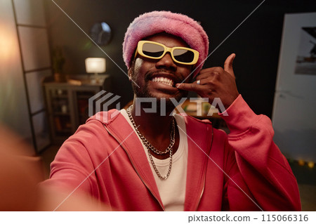 POV portrait of African American man filming viral dance video and wearing pink outfit 115066316