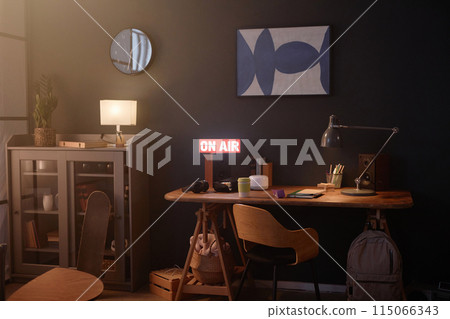 Background image of dark teen bedroom interior with On air sign and minimal wooden desk copy space 115066343