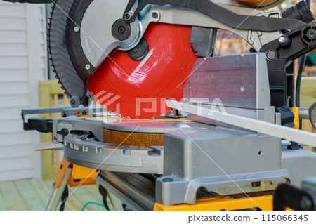 In this case, contractor is cutting wooden moldings with circular saw before installing them In this case, contractor is cutting wooden moldings with circular saw before installing them 115066345