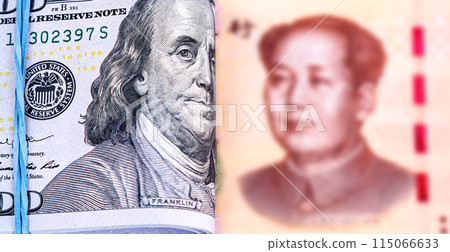 Folded american dollars banknotes with Benjamin Franklin portrait wrapped by rubber band and chinese banknote with Mao Zedong portrait Folded american dollars banknotes with Benjamin Franklin portrait wrapped by rubber band and chinese banknote with Mao Zedong portrait 115066633