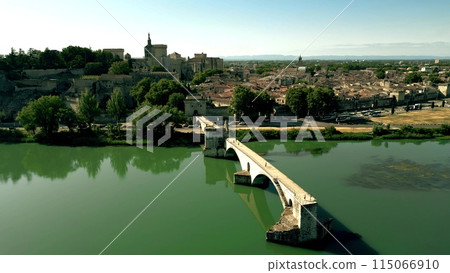 Aerial shot of the city of Avignon and famous broken Saint Benezet bridge over the Rhone River, France Aerial shot of the city of Avignon and famous broken Saint Benezet bridge over the Rhone River, France 115066910