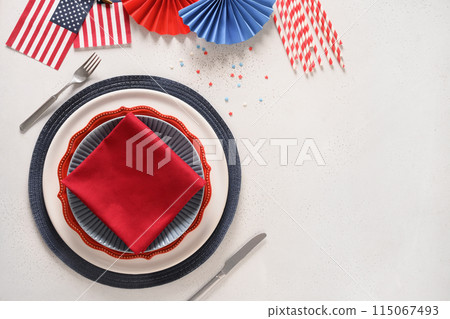 Festive table setting and decoration in American flag colors on white background. Independence Day. Happy Memorial Day. View from above. Copy space. 115067493