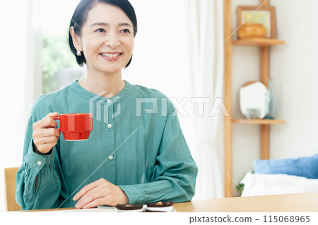 A woman drinking coffee A woman drinking coffee 115068965