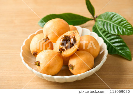 Large loquats on a plate Large loquats on a plate 115069020