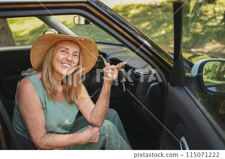 Excited senior woman sitting in new car outdoors holding keys, smiling, enjoying newly bought auto. Driving courses, insurance, road trip. Retired people activity. Happy female client car dealership. Excited senior woman sitting in new car outdoors holding keys, smiling, enjoying newly bought auto. Driving courses, insurance, road trip. Retired people activity. Happy female client car dealership. 115071222