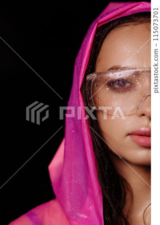 Woman wearing pink raincoat and large clear garden or safety glasses Woman wearing pink raincoat and large clear garden or safety glasses 115073701