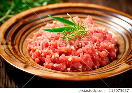 Fresh raw ground beef on a wooden cutting board with herbs and spices, perfect for recipes and culinary uses 115075087