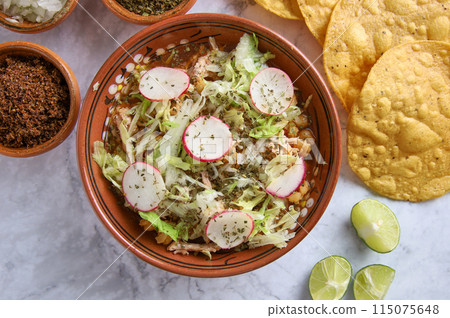 Pozole rojo, Mexican corn soup, traditional food in Mexico made with corn kernels and pork. Pozole rojo, Mexican corn soup, traditional food in Mexico made with corn kernels and pork. 115075648