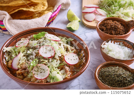 Pozole rojo, Mexican corn soup, traditional food in Mexico made with corn kernels and pork. Pozole rojo, Mexican corn soup, traditional food in Mexico made with corn kernels and pork. 115075652