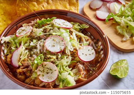 Pozole rojo, Mexican corn soup, traditional food in Mexico made with corn kernels and pork. Pozole rojo, Mexican corn soup, traditional food in Mexico made with corn kernels and pork. 115075655