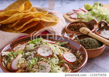 Pozole rojo, Mexican corn soup, traditional food in Mexico made with corn kernels and pork. Pozole rojo, Mexican corn soup, traditional food in Mexico made with corn kernels and pork. 115075656