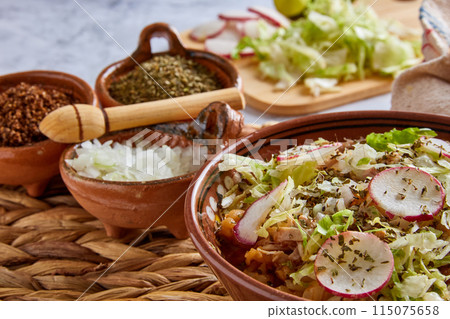 Pozole rojo, Mexican corn soup, traditional food in Mexico made with corn kernels and pork. Pozole rojo, Mexican corn soup, traditional food in Mexico made with corn kernels and pork. 115075658