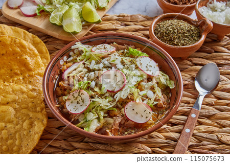 Pozole rojo, Mexican corn soup, traditional food in Mexico made with corn kernels and pork. Pozole rojo, Mexican corn soup, traditional food in Mexico made with corn kernels and pork. 115075673