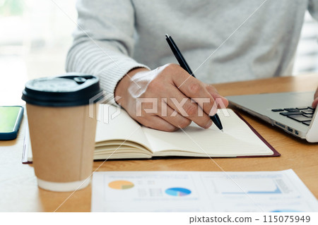 Hands of a man studying 115075949
